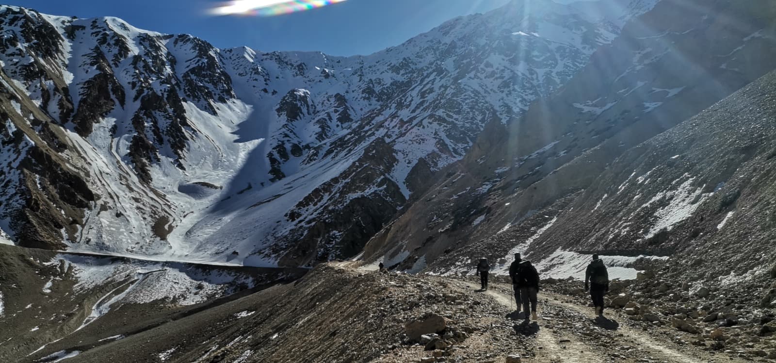 Global outreach — team trekking toward mountain peaks